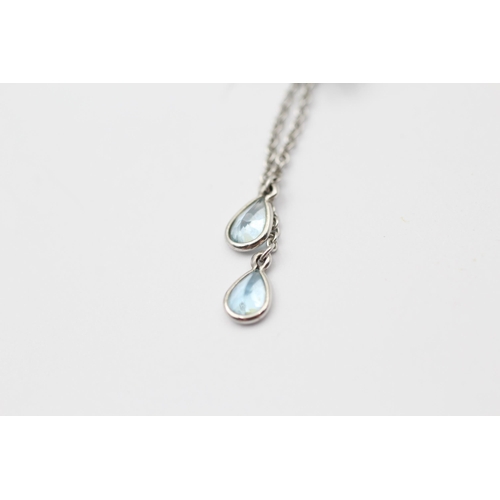 168 - 18ct White Gold Blue Topaz Floral Pendant Necklace (6.6g)