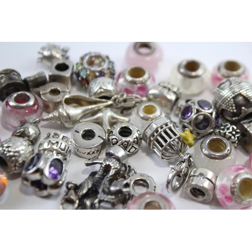 181 - A Collection Of Silver Branded Charms