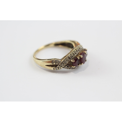 103 - 9ct Gold Ruby Three Stone Ring With Diamond Frame (2.9g) Size  O