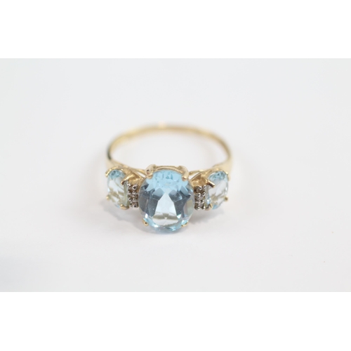 137 - 9ct Gold Blue Topaz Three Stone Ring With Diamond Dividers (1.9g) Size  O 1/2