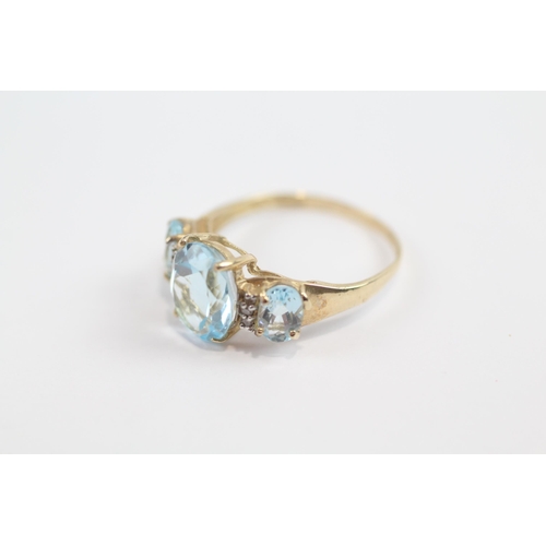 137 - 9ct Gold Blue Topaz Three Stone Ring With Diamond Dividers (1.9g) Size  O 1/2