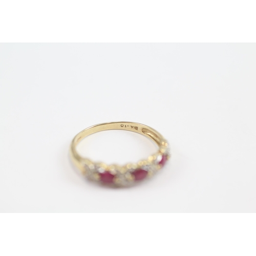 63 - 9ct Gold Ruby Three Stone Ring With Diamond Surround (2.1g) Size  R