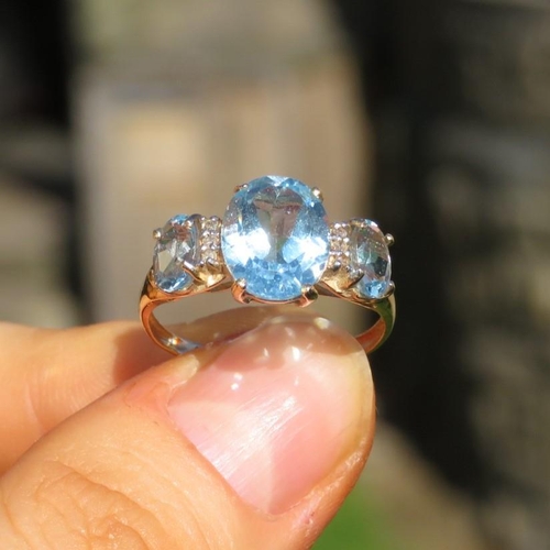 137 - 9ct Gold Blue Topaz Three Stone Ring With Diamond Dividers (1.9g) Size  O 1/2