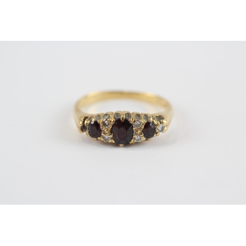 111 - 9ct Gold Diamond & Garnet Seven Stone Ring (3.5g) Size  M