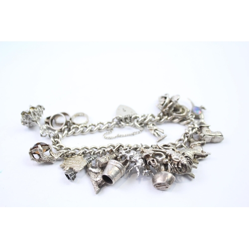 217 - Silver charm bracelet with heart padlock clasp (83g)