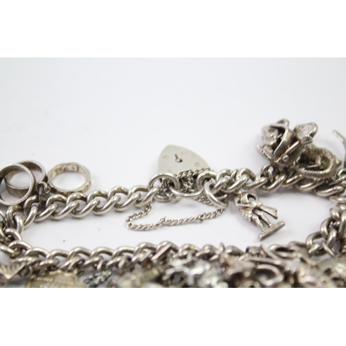 217 - Silver charm bracelet with heart padlock clasp (83g)