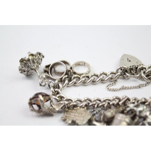 217 - Silver charm bracelet with heart padlock clasp (83g)