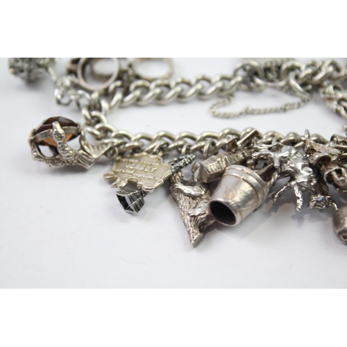 217 - Silver charm bracelet with heart padlock clasp (83g)