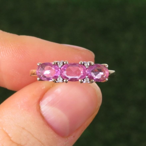 90 - 9ct Gold Pink Sapphire Three Stone Ring With Diamond Spacers (2.1g) Size  O