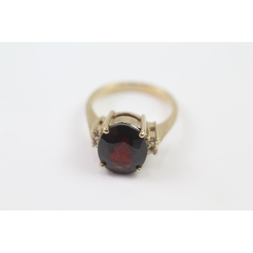 102 - 9ct Gold Garnet Single Stone Ring With White Gemstone Sides (5.3g) Size  N