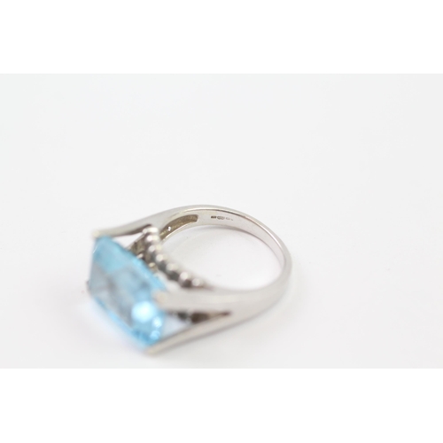 137 - 9ct White Gold Blue Topaz Cocktail Ring (6.1g) Size  M