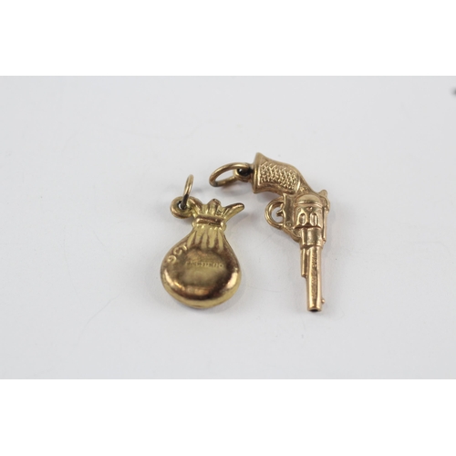 180 - 2 x 9ct gold charm pendant inc. jar & gun (1.4g)