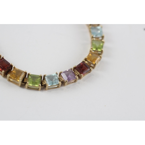 218 - 9ct gold amethyst, topaz, peridot, citrine & garnet tennis bracelet (7.4g)