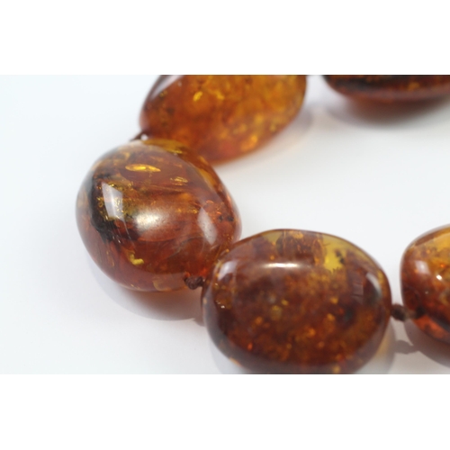 246 - 9ct gold clasped baltic amber bead necklace (99.7g)