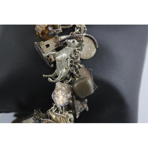 309 - Silver charm bracelet including souvenir charms (105g)