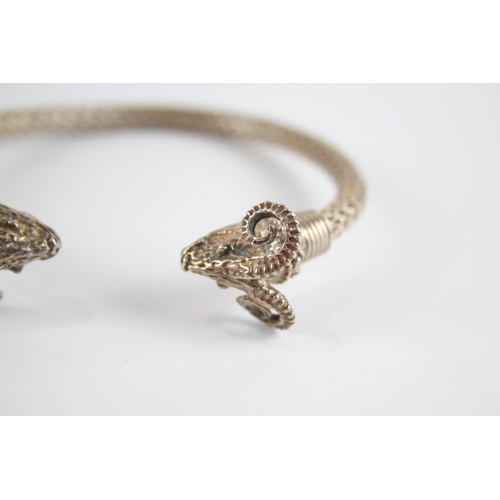 336 - Silver wirework torque bangle with rams heads (27g)