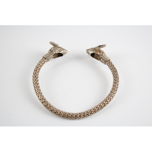 336 - Silver wirework torque bangle with rams heads (27g)