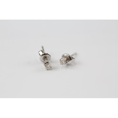 176 - 18ct white gold diamond paired stud earrings (1.1g)