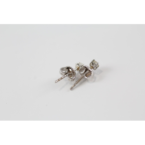 176 - 18ct white gold diamond paired stud earrings (1.1g)