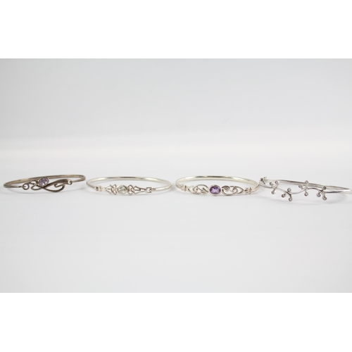 203 - Four silver CZ bangles including Celtic (41g)