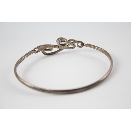 203 - Four silver CZ bangles including Celtic (41g)