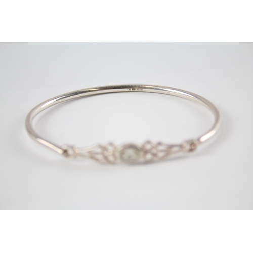 203 - Four silver CZ bangles including Celtic (41g)