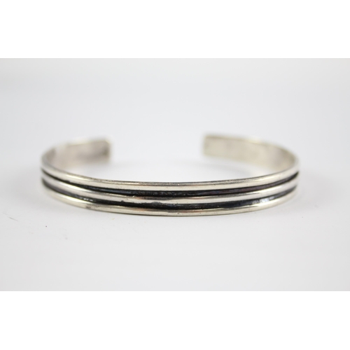 204 - Three silver modernist bangles (75g)