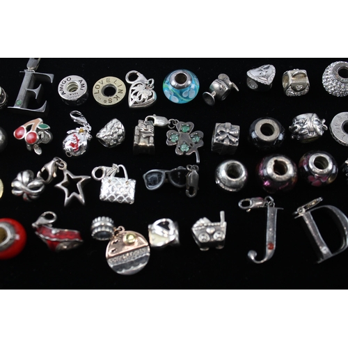 207 - A collection of silver mixed brand charms (112g)