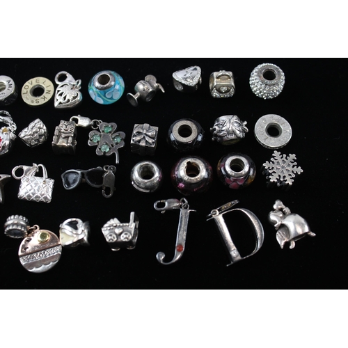 207 - A collection of silver mixed brand charms (112g)