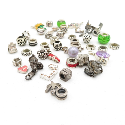 209 - A collection of silver mixed brand charms (97g)