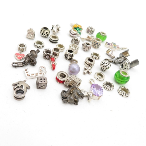 209 - A collection of silver mixed brand charms (97g)