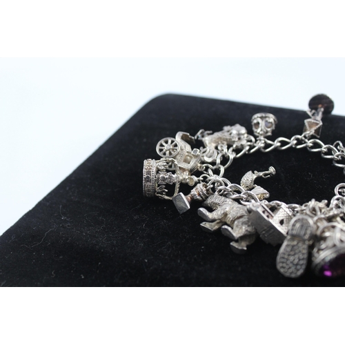 211 - Silver charm bracelet including 1977 Queen charm (86g)