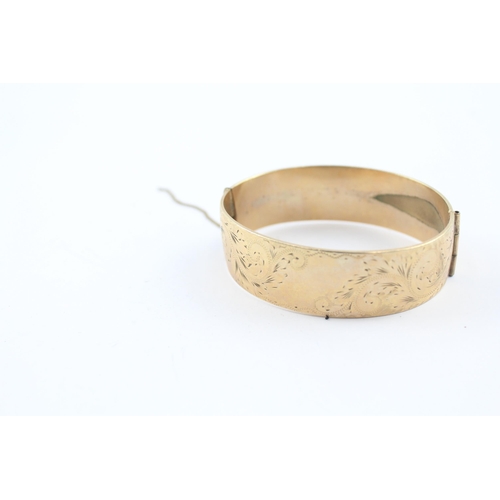 230 - 9ct rolled gold bangle with etched design (52g)