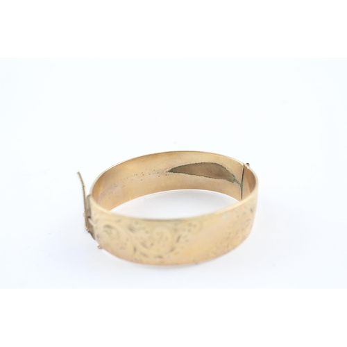 230 - 9ct rolled gold bangle with etched design (52g)