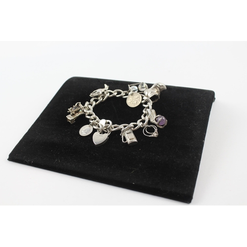 231 - Silver charm bracelet including coin charm (107g)