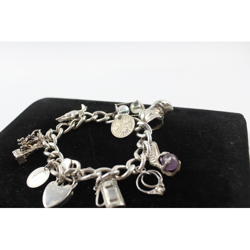 231 - Silver charm bracelet including coin charm (107g)