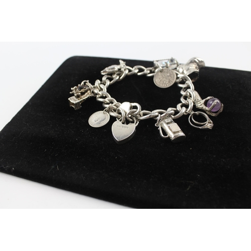 231 - Silver charm bracelet including coin charm (107g)