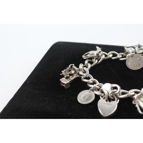 231 - Silver charm bracelet including coin charm (107g)