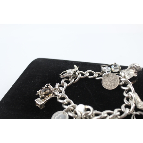 231 - Silver charm bracelet including coin charm (107g)