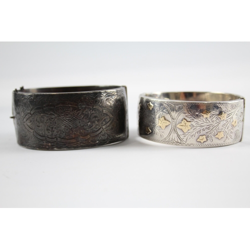 239 - Two silver antique bangles including gold detailing (114g)