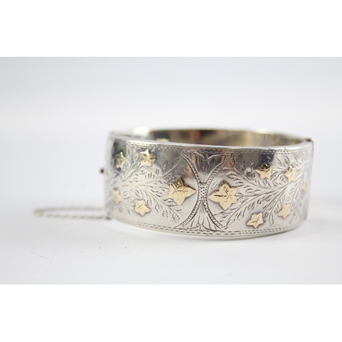 239 - Two silver antique bangles including gold detailing (114g)