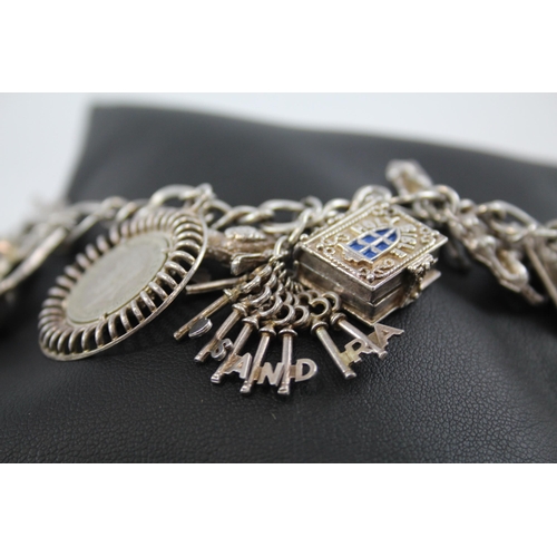 245 - Silver charm bracelet including opening charms (59g)