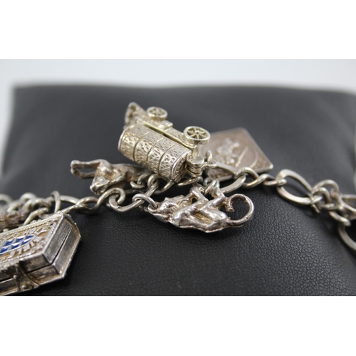 245 - Silver charm bracelet including opening charms (59g)