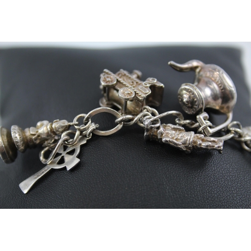 245 - Silver charm bracelet including opening charms (59g)