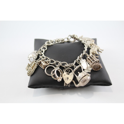 281 - Silver charm bracelet including half dollar coin (74g)