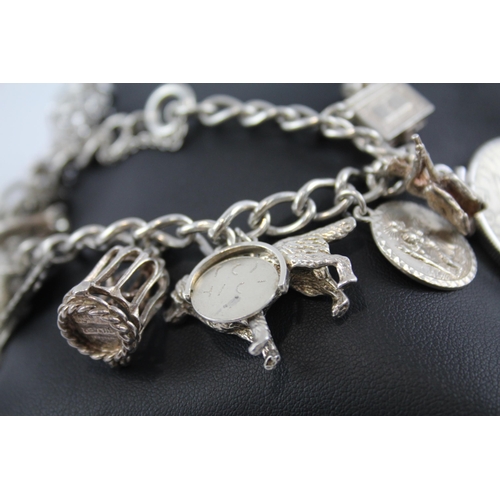 281 - Silver charm bracelet including half dollar coin (74g)