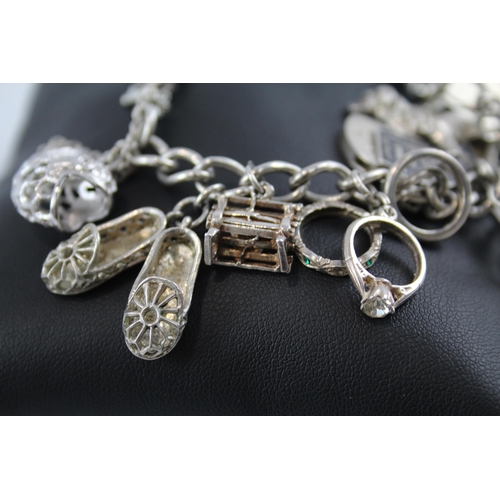 281 - Silver charm bracelet including half dollar coin (74g)