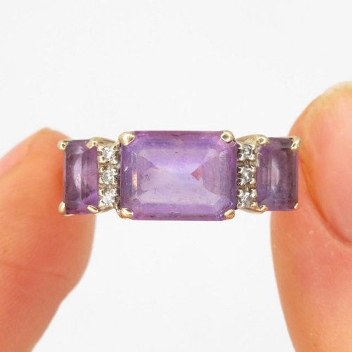 82 - 9ct gold amethyst & diamond trilogy ring (2.8g) Size  M