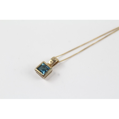 137 - 9ct gold blue topaz & diamond pendant & chain (1.9g)