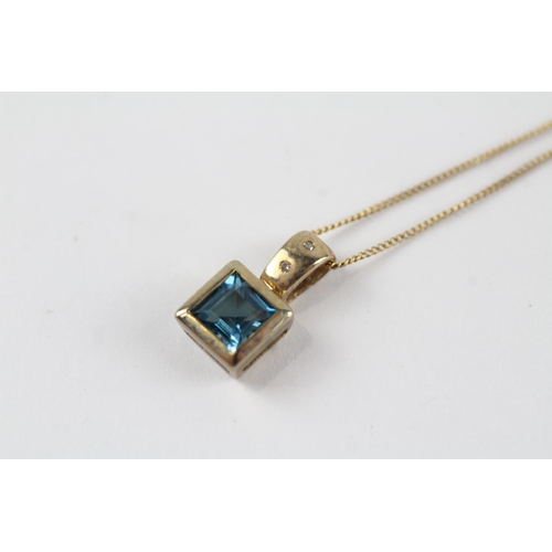 137 - 9ct gold blue topaz & diamond pendant & chain (1.9g)